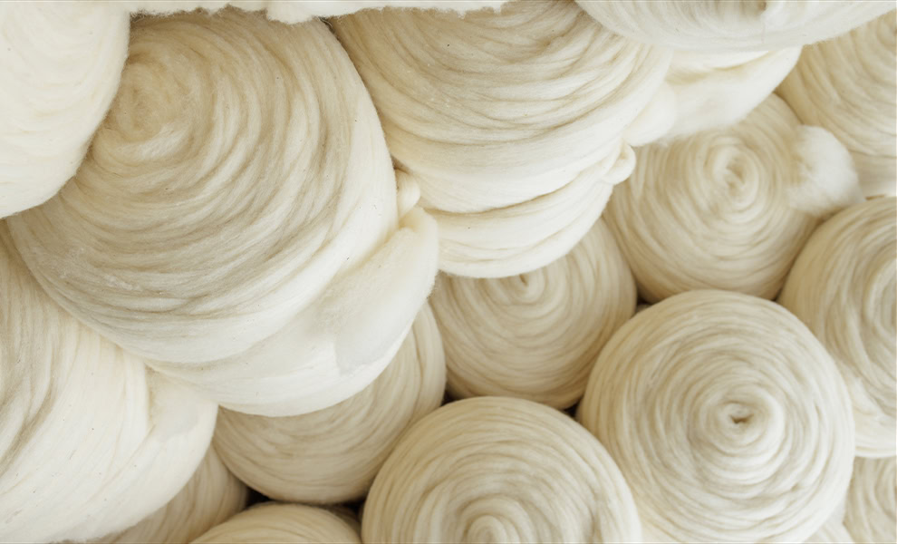 Rolls of carded wool fibre