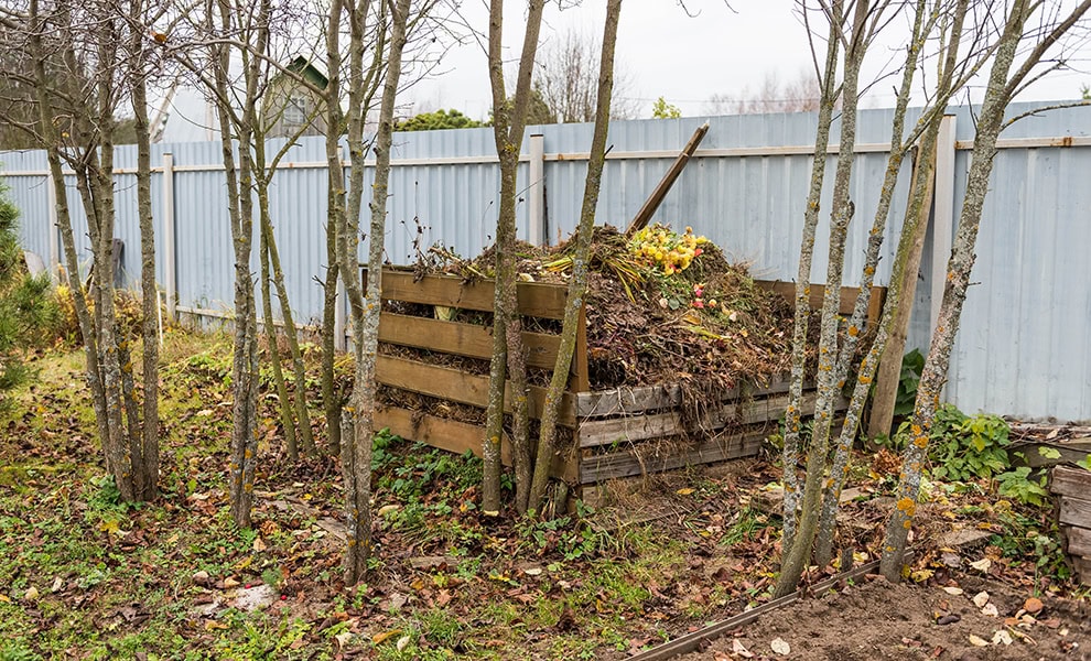Large compost heap made with wood boards